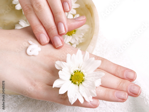 female applying cream to her hands