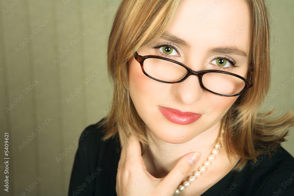 Young blond business woman with pearl necklace Young blond business woman with pearl necklace