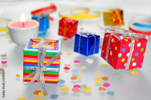 Colorful gifts with shining ribbons on white background