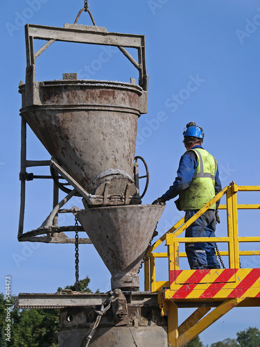 Worker pours cement into the well, close-up