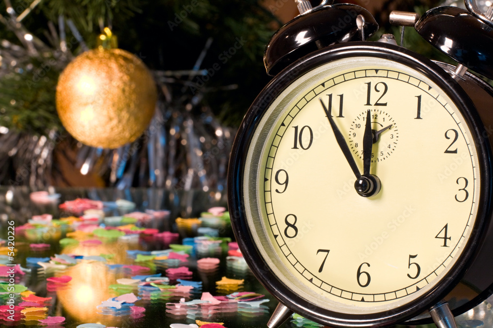 Image of clock on the background of branch with ball Image of clock on the background of branch with ball