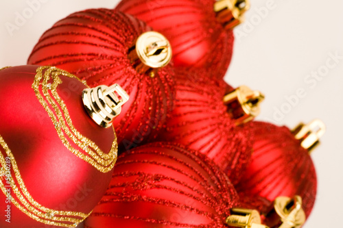 Photo of several red christmas balls on a white background