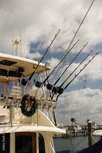row of fishing rods and reels on sport fishing boat