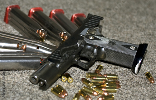 pistol and ammunition in magazine and bullets.