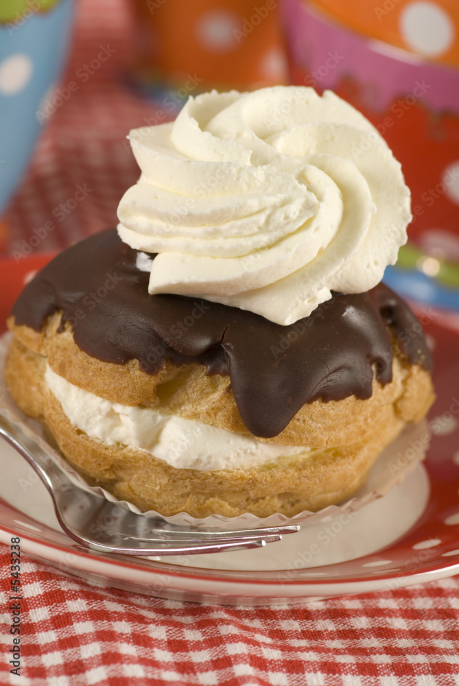 a chocolate eclair with whipped cream a chocolate eclair with whipped cream