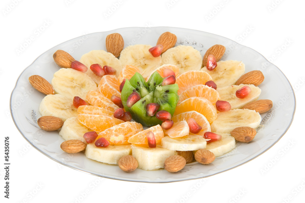 Delicious fruit salad on white round plate isolated on white Delicious fruit salad on white round plate isolated on white