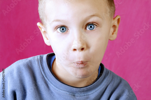 little boy with blue eyes confused
