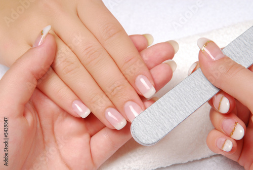 Studio nail — beautician polishing female nails