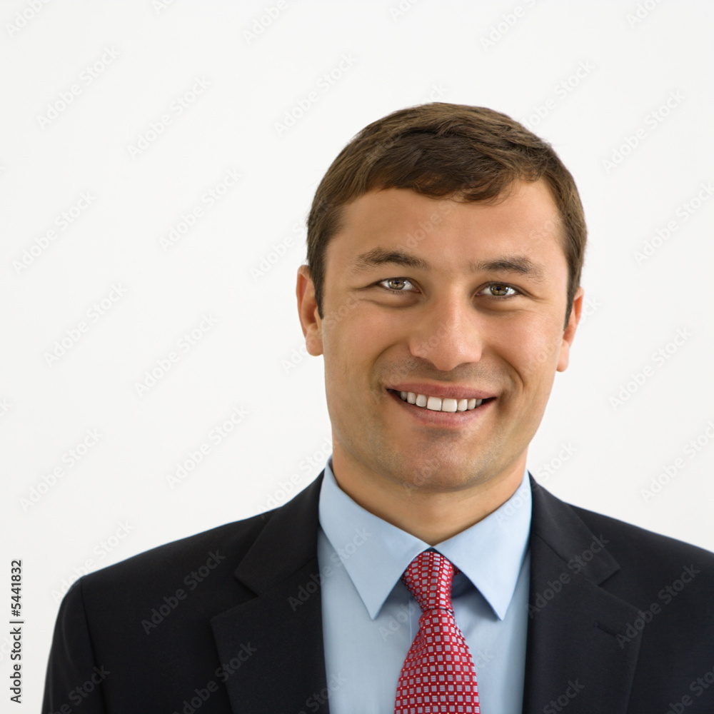 Portrait of smiling businessman against white background. Portrait of smiling businessman against white background.