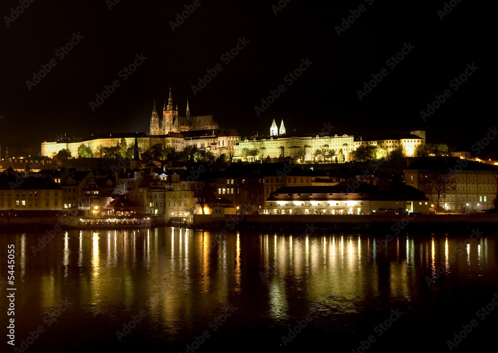Hradcany and castle at night reflecting in Vltava, Prague