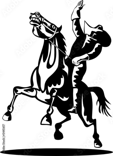 Rodeo cowboy riding a bucking bronco