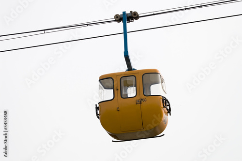 yellow cable car hanging in the sky