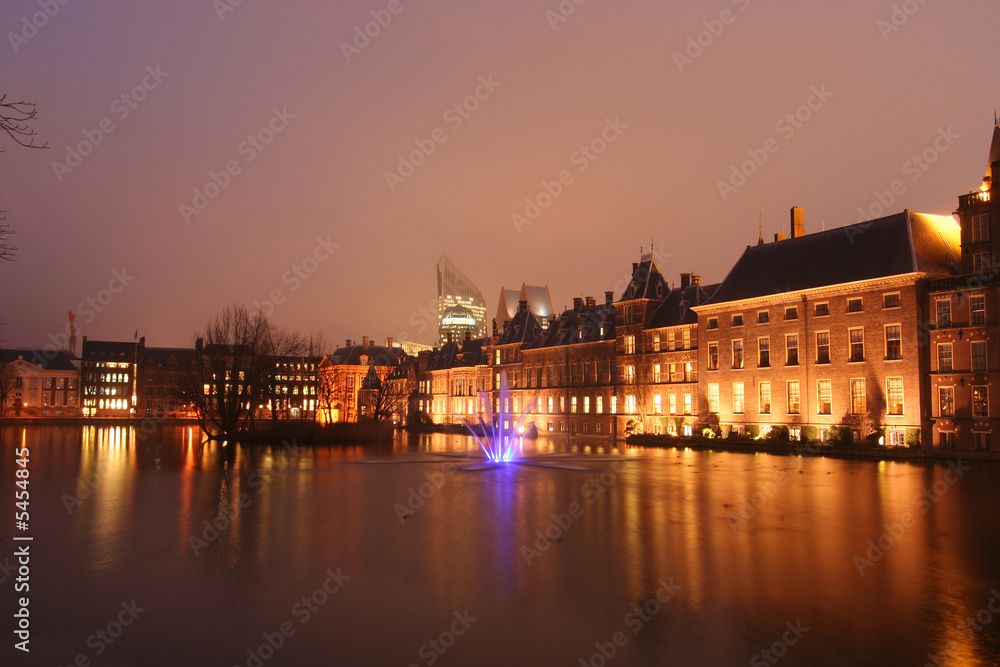 Dutch parliament with coloured light fountain in the evening