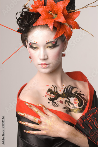The young Japanese woman on a grey background