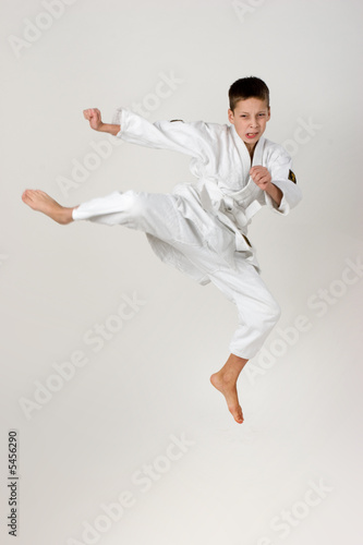 boy jump in the kimono, practice of aikido