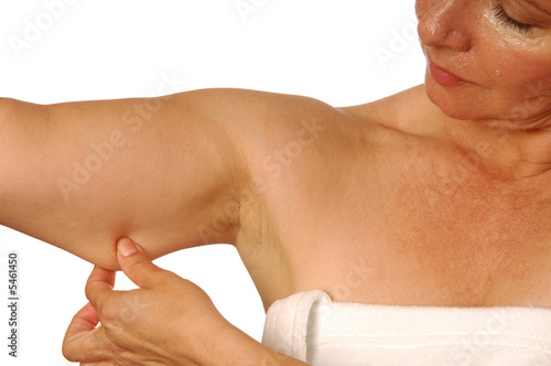 Woman examining unwanted love handle after a shower