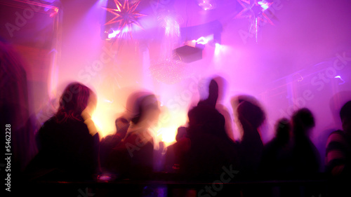 Nightclub scene with dance floor crowd in motion