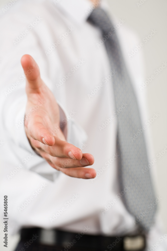 Conceptual photo of businessman extending a helping hand Conceptual photo of businessman extending a helping hand