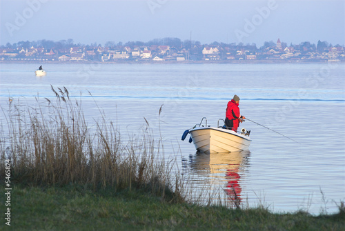 Man in fishing-boat sport fishing