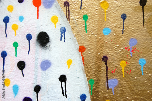 Detail of a wall covered with dots. Dripping paint.