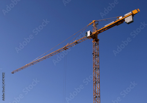 Industrial construction development. Yellow steel crane 
