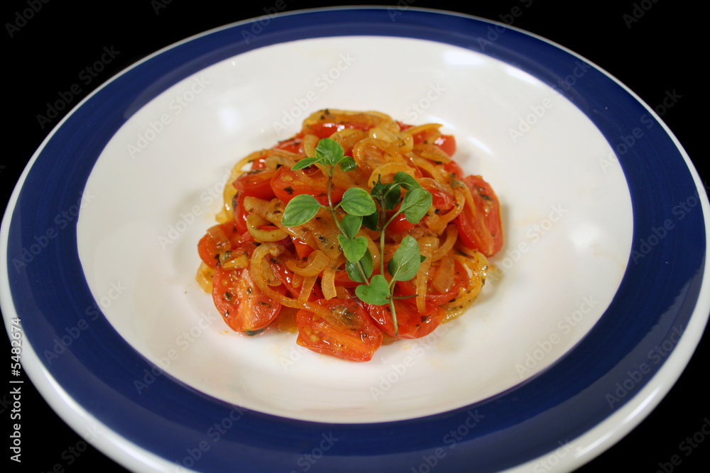Warm salad consisting of tomatoes and onion with oregano. Warm salad consisting of tomatoes and onion with oregano.