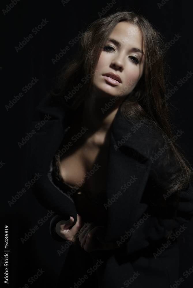 an attractive woman with long brown hair and coat