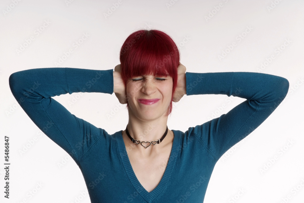 Fototapeta premium a woman with red hair and turned nose holds ear closed