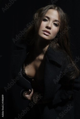 an attractive woman with long brown hair and coat