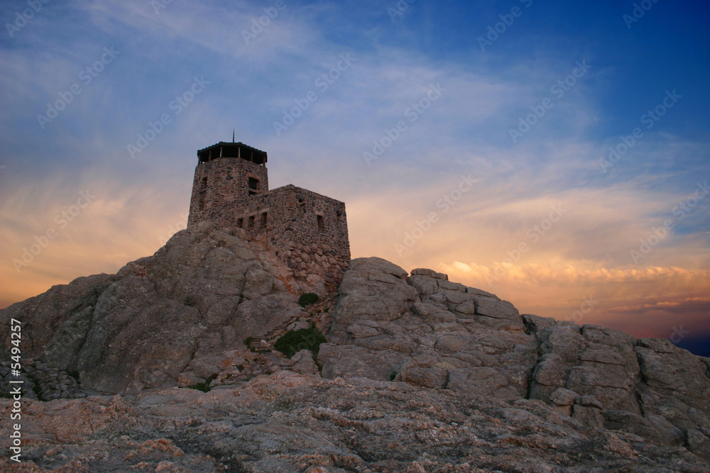 mountaintop castle with dramatic sunset sky