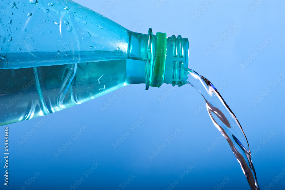 natural water pouring from a green plastic bottle natural water pouring from a green plastic bottle