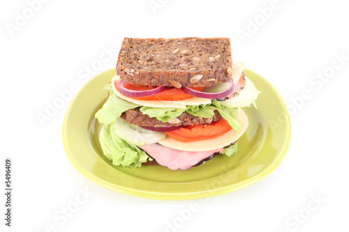 big sandwich on green plate isolated on white