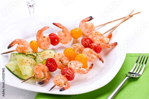 Dinner settiing of spicy grilled shrimps and basil tomato salad photo