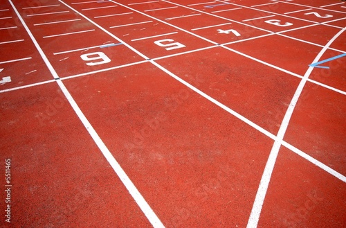 numbers of a racetrack, on red tarmac, for runners
