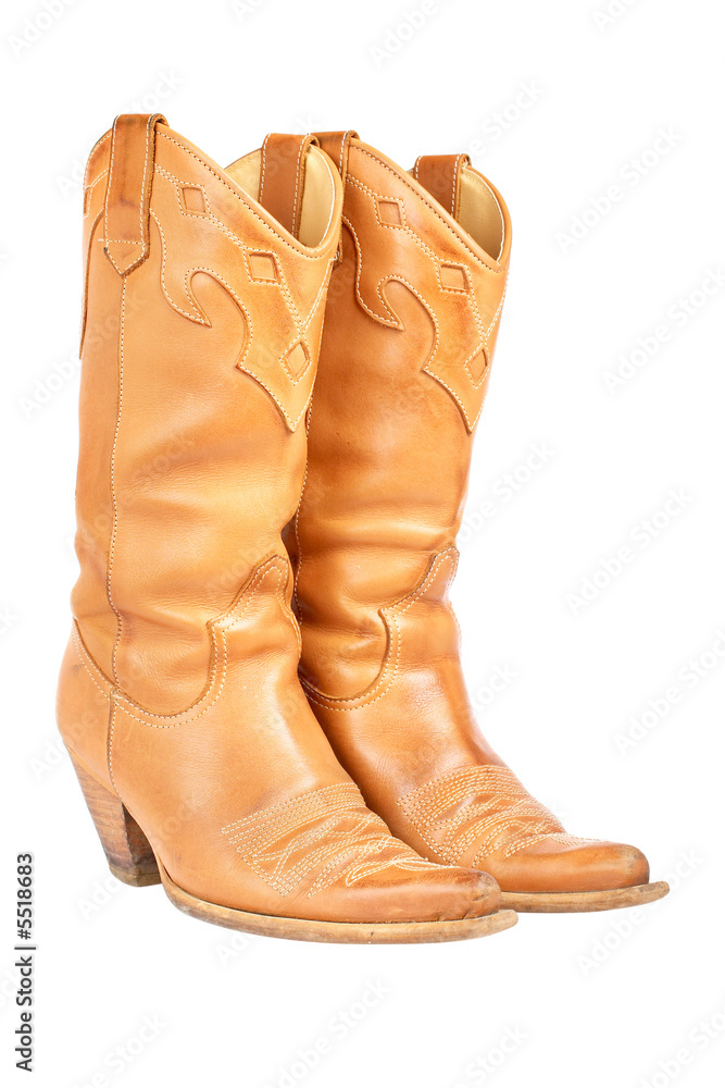 A pair of used cowboy boots isolated on white background A pair of used cowboy boots isolated on white background