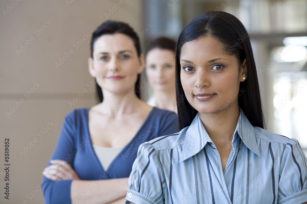 Relaxed and confident businesswoman with team behind Relaxed and confident businesswoman with team behind