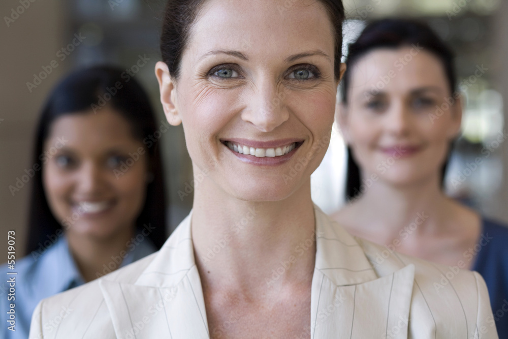 Confident businesswoman with team behind Confident businesswoman with team behind