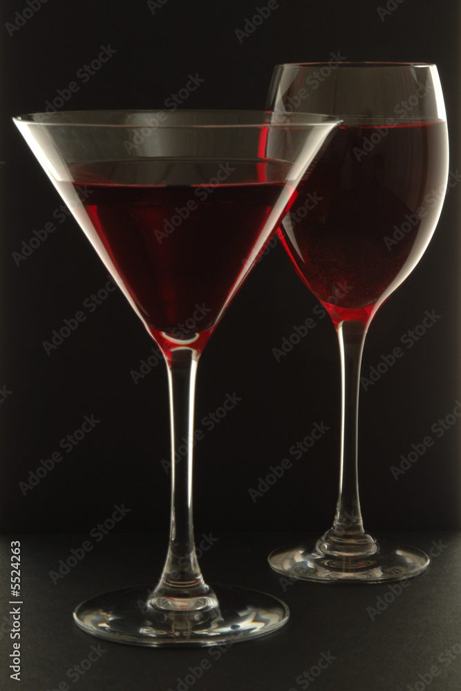 Two Glasses with red liquid on black background Two Glasses with red liquid on black background