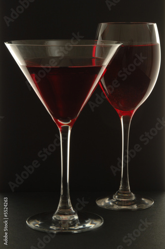 Two Glasses with red liquid on black background