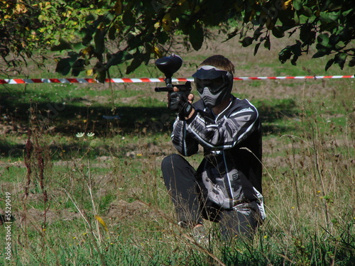 paintballer with marker gun and protective mask