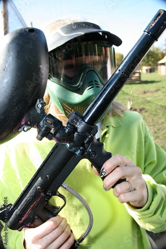 paintballer with marker gun and protective mask