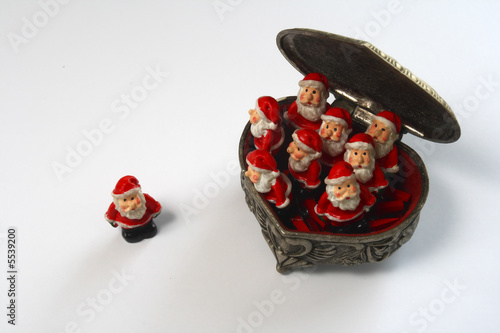 Many Santa Claus in box on white back