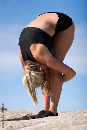 Young woman doing yoga outdoors