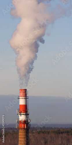 Stand-alone red-white boiler-house chimney smoking photo