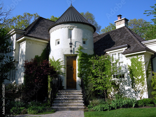 Stucco house with turret over entrance photo