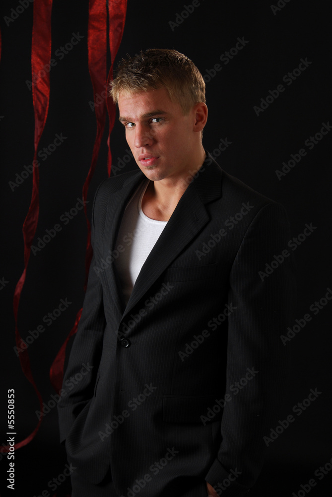 Fototapeta premium A man in dark clothing slips out of the shadows