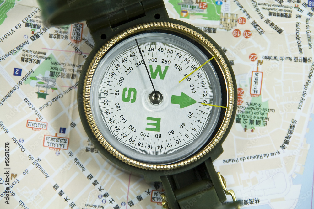 view of a compass on a map. view of a compass on a map.