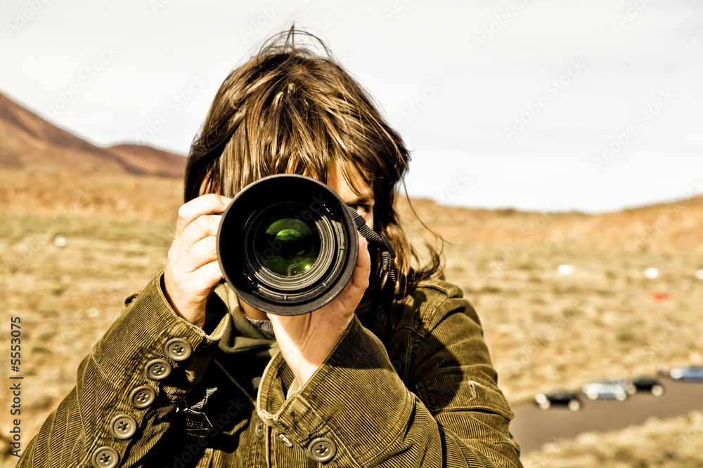 Fototapeta premium Brown haired woman taking picture.