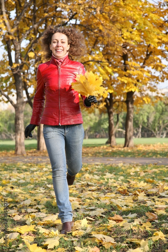 girl in the red jacket in the park in autumn girl in the red jacket in the park in autumn