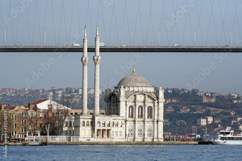 Iústanbul Bosphorus Bridge with a mosgue at coast side photo